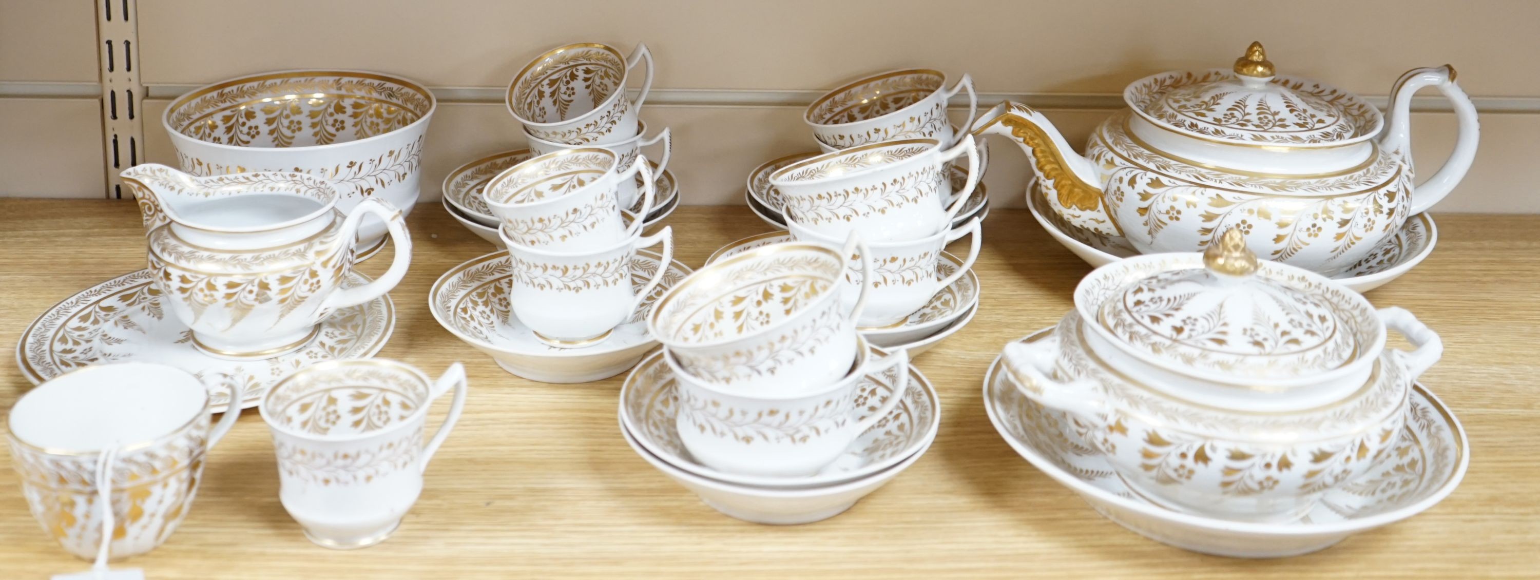 An early 19th century English porcelain gilt decorated part tea and coffee set